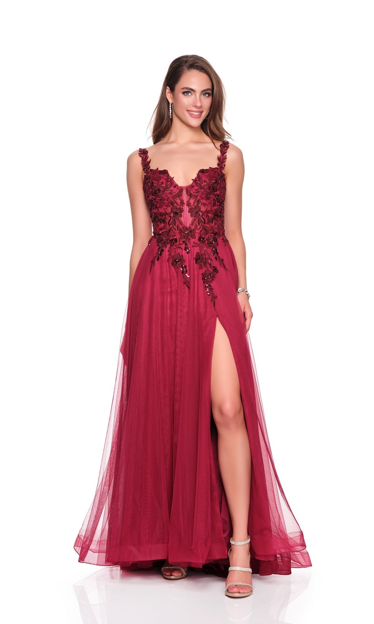 A woman poses elegantly against a white background in the Long Prom Dress: Dave and Johnny 12808, a sleeveless burgundy gown featuring an embroidered bodice, floral embellishments, and a high slit.